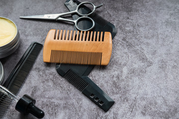 Scissors, combs, wax and balm for trimming a beard. Barber kit. Flat lay. Copy space.
