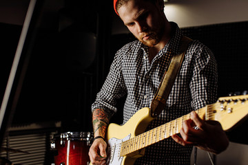 talented caucasian musician play on electric guitar his favourite song, rock music performer...