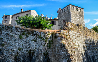 House and part of the fortified wall in the Saint Paul de Vence village, a medieval town completely preserved. In Provence region, southeastern France.