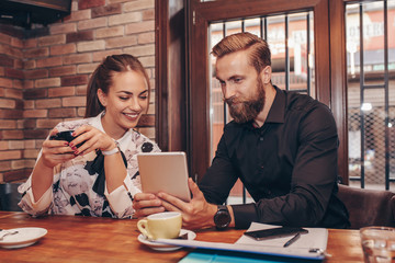 Business people discussing business ideas looking at digital tablet.