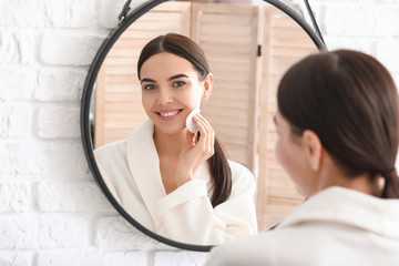 Beautiful young woman with cotton pad at home © Pixel-Shot
