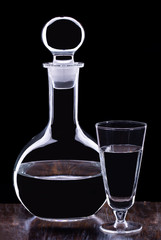 Vodka in glass graphine with glass on wooden table