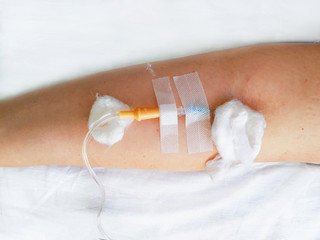hand with an intravenous dropper