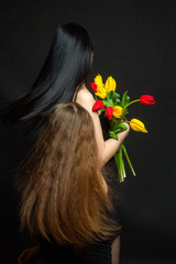 Naklejka premium Portrait of girl and woman with tulips in the Studio
