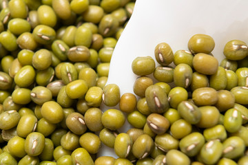 Bunch of Green Mung Beans in a White Ceramic Bowl. Macro shot. Cooking traditional dishes