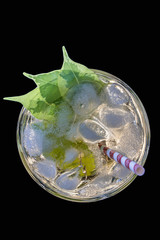 Cocktail mojito with straw top view ice lemon straws in an expensive bar restaurant, in tropical beach balearic Islands, mojito cocktail quenches thirst slightly hoppers raises mood and brings good lu