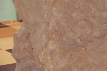 A large beige stone. Imitation of a stone in the room.