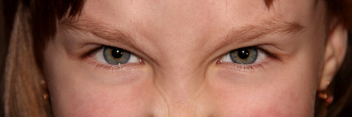 Angry children's eyes. Part of the child's face.