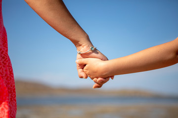 Mother and daughter hands holding