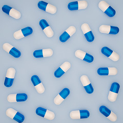 3d rendering illustration of pharmacy medicament capsule, drug and pills above view. Drugs blue and white capsule pattern.