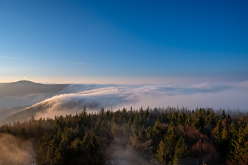 Sunrise in mountains in spring with fog and beautiful forest, Czech Beskydy