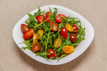 home cooked salad of arugula and cherry tomatoes