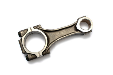 Connecting rod from a car engine. Isolated on white background. Spare parts.