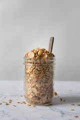 Homemade granola in a jar with a wooden spoon