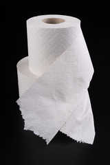 White toilet paper on a dark table. Articles for daily hygiene.