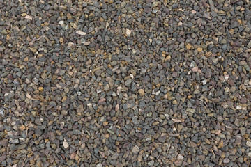 Small cobbles, cobblestones on the ground. Texture background or backdrop.