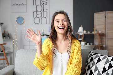 Young woman using video chat at home