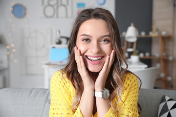 Young woman using video chat at home