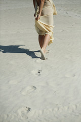 Traces of a woman leaving the sand.