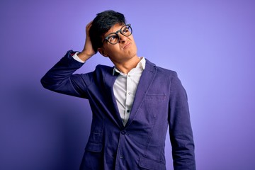 Young handsome business man wearing jacket and glasses over isolated purple background confuse and wondering about question. Uncertain with doubt, thinking with hand on head. Pensive concept.