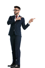 businessman standing and pointing behing him with both hands