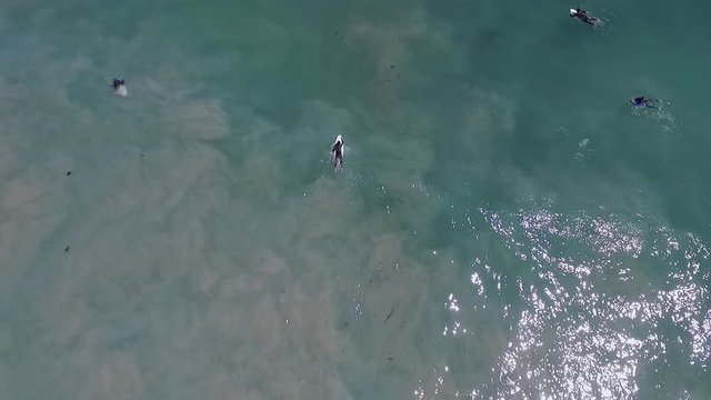 Aerial view of a surfer paddling back into the lineup trough the waves in Big Bay, South Africa