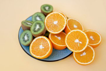 kiwi and oranges on a plate