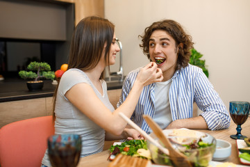 Woman feeding his husband at moren kitchen