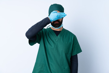 Surgeon man in green uniform over isolated background covering eyes by hands. Do not want to see something