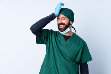 Surgeon man in green uniform over isolated background has realized something and intending the solution