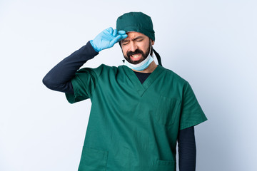 Surgeon man in green uniform over isolated background with tired and sick expression