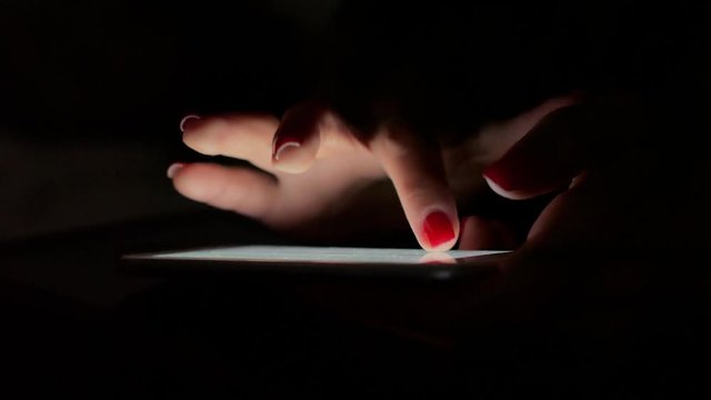 woman's hand quickly types text on the tablet.