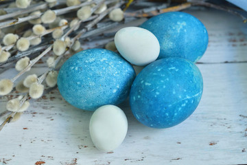 Fototapeta na wymiar Blue Easter eggs on light background. Naturally Eggs painted with hibiscus and red cabbage with marble stone effect.Eco paint. Happy Easter card