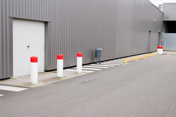 white door emergency exit from a grey warehouse