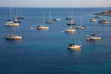 Anchored sailboats off the coast of Kastos island, Ionian sea, Greece in summer.
