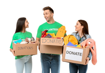 Volunteers with donations for orphans on white background