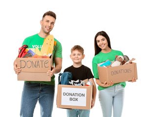 Volunteers with donations for orphans on white background