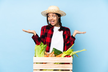 Young farmer Woman holding fresh vegetables in a wooden basket holding copyspace with two hands