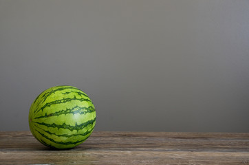 Delicious Watermelon on Wood Table and Grey Wall