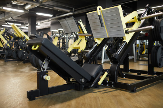 Background image of modern exercise machines in row in sports interior, copy space