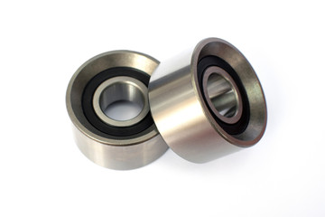 Tension roller of a timing belt of an internal combustion engine on a white background. Engine spare parts.