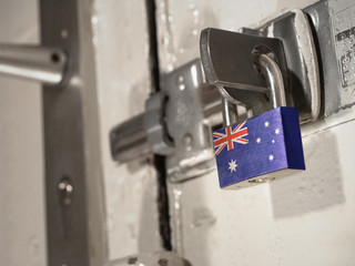 A bolted door secured by a padlock with the national flag of Australia on it.(series)