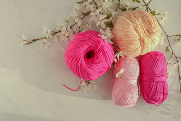 Colorful cotton yarn balls on light background