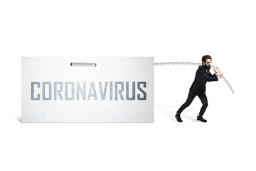 Caucasian businessman pulling inscription coronavirus on a white sheet, global virus crisis concept