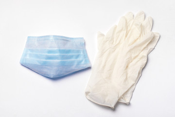 protective medical mask and gloves on a gray background