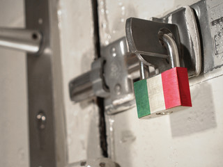 A bolted door secured by a padlock with the national flag of Italy on it.(series)