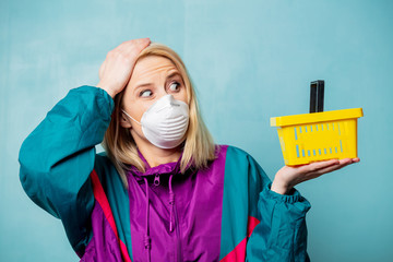 Style blonde woman in 90s clothes and face mask with shopping basket