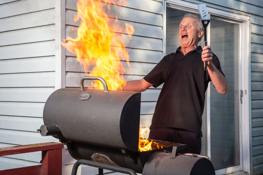 Man with flaming BBQ fire