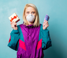 woman in 90s clothes and face mask with gift box and money