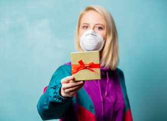 woman in 90s clothes and face mask with gift box